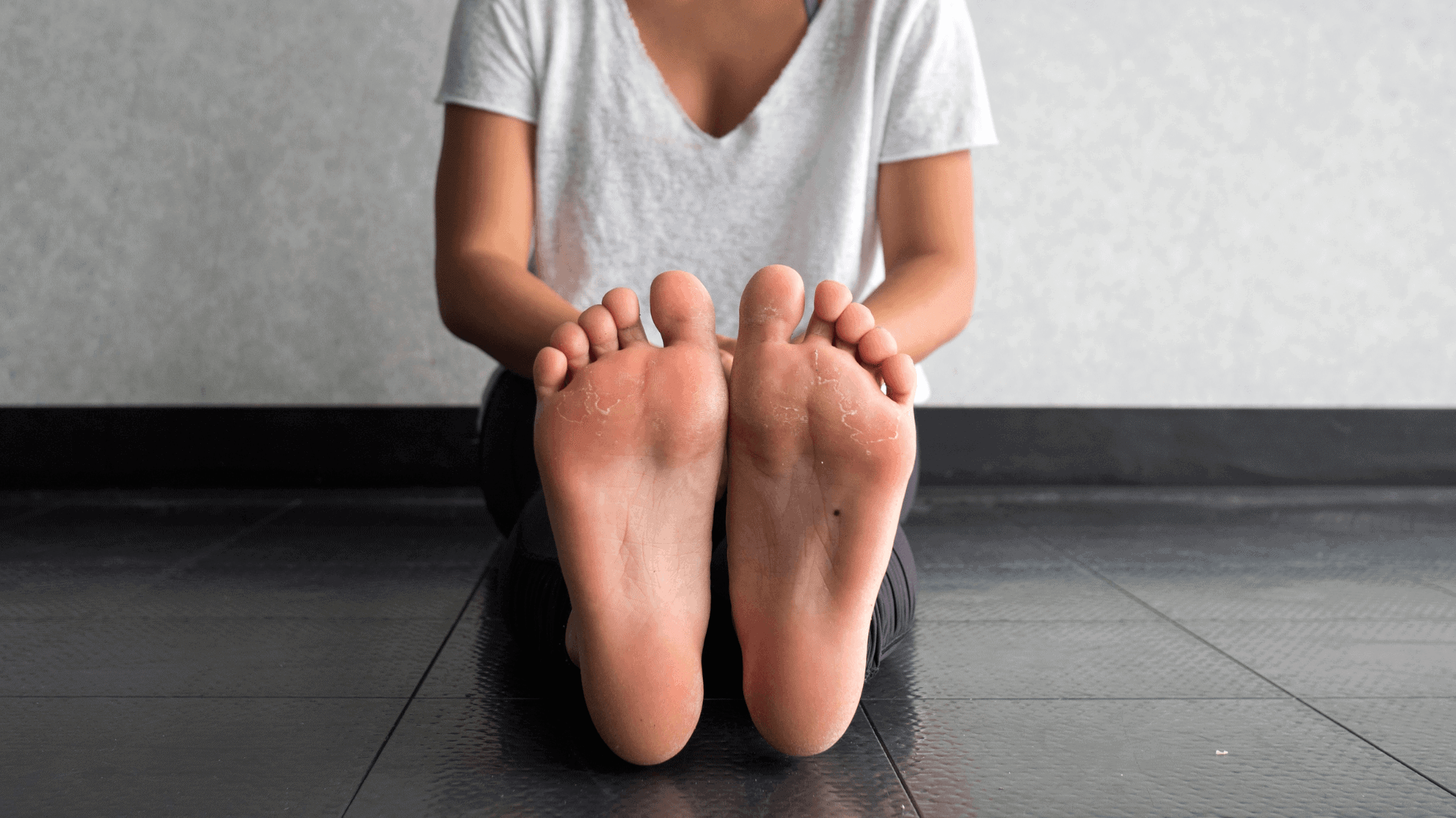 woman sitting on floor legs outstretched bare feet
