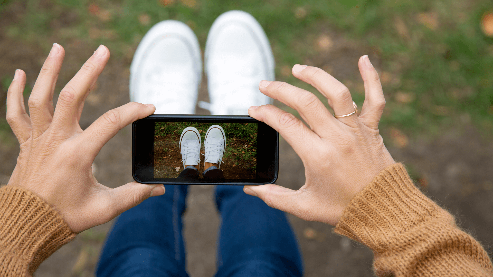woman taking picture of feet in shoes